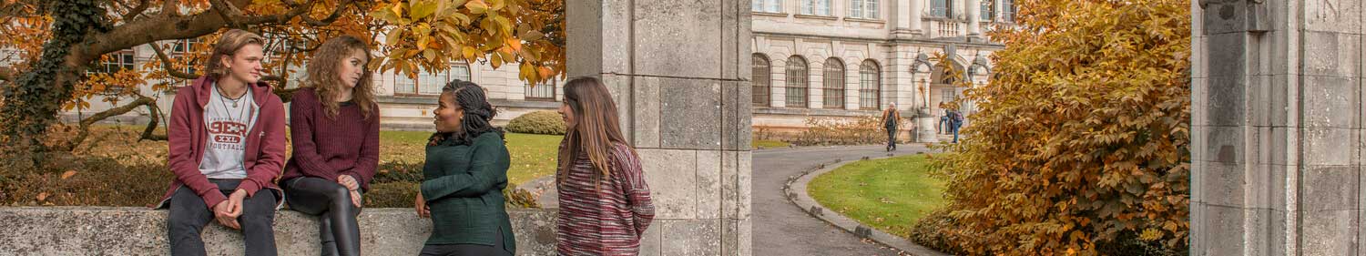 Four students in from of the main building at Cardiff University